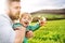 A father with his toddler son outside in spring nature.