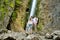 Father and his two daughters admiring Siklawica Waterfall in Strazyska Valley in Tatra Mountains, Poland