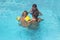 Father and his two daughters enjoys the pool on a hot summer day