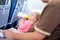 Father holding baby daughter during flight on airplane going on vacations. Baby girl drinking formula milk from bottle