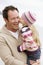 Father holding daughter kissing him at beach