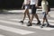 Father holding hands with his kids while on pedestrian crossing