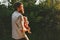 Father holding infant baby walking together in forest