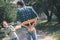 Father holding a toy plane behind his back, a boy feeling excited