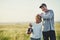 Father, kid fun and rugby portrait in a countryside field for bonding in nature. Mockup, dad and young boy child