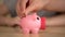 Father and kid putting money in piggy bank for purchase, saving family budget