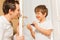 Father and kid son repairing door handle together