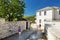 Father and kids exploring Monodendri village with its traditional stone-made buildings and stone walkways, Zagoria area, Epirus,