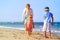 Father and kids play on beach