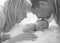 Father kisses a newborn baby. Happy father`s day! Mom, dad and baby. Black and white portrait of a family with a newborn