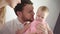 Father kissing baby girl. Dad kiss daughter infant at home. Male tenderness