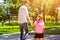 Father leads daughter to school in first grade. first day at school. back to school