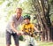 Father learn his son to ride bicykle