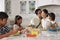 Father Leaving For Work After Family Breakfast In Kitchen