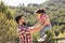 Father lifting little girl in the viewpoint of a forest