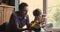 Father and little boy repairing toy car together at home