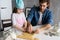 Father and little daughter baking pastries. Family having fun in kitchen and getting ready for a party.