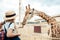 father and little daughter looking at reticulated giraffe