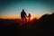 Father and little daughter travel in mountains at sunset