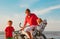 father with little son and daughter biking at beach