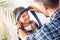 Father and little son at home dad sitting putting on tie on boy smiling playful close-up