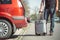 Father loading a luggage to the car, preparing for a vacation or holiday abroad, transportation concept