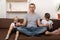 Father meditates while children using gadgets. Dad has calmed his sons and relaxing