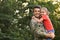 Father in military uniform holding his little daughter at park