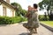 Father in military uniform hugging little daughter