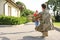 Father in military uniform and little daughter running to him