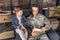 father in military uniform and son reading book together