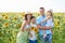 Father, mother and baby daughter in sunflowers field.Children Protection, mothers and Fathers Day. Family Summer vacation