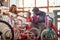 Father and mother buying new bicycle and helmets for little girl