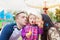 Father, mother and daughter blowing bubbles, family in amusement