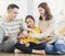 Father, mother and daughter holding a piggy bank and money at home. Family and saving for future concept