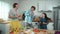 Father, mother and daughter making breakfast while dancing together. Pedagogy.