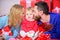 Father, mother and doughter child. Valentines day. Red boxes. Love and trust in family. Bearded man and woman with