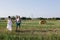 Father and mother hug her little daughter outdoor in field