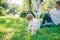 Father and mother play with his daughter with soapbubble