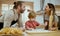 Father and mother teaching baby son kneading dough on kitchen counter at home. Parents and boy kid enjoy and fun indoors activity