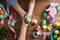 Father, mother and their child holding painted Easter egg on wooden background