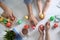 Father, mother and their child painting Easter eggs on wooden background