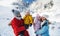 Father and mother with two small children in winter nature, standing in the snow.