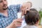 Father mows his son at home. the need to update the hair of the child