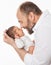 Father with Newborn. Happy Dad kissing Baby. Smiling Man holding one Month little Child in Hands over White. Parent playing