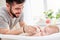 Father on parental leave washes his baby