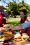 Father passing plate of burger to son in park