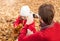 Father photograph his girl child playing in an autumn park