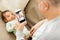 Father photographing baby by smartphone