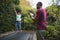 Father photographing son while jumping on trampoline at park